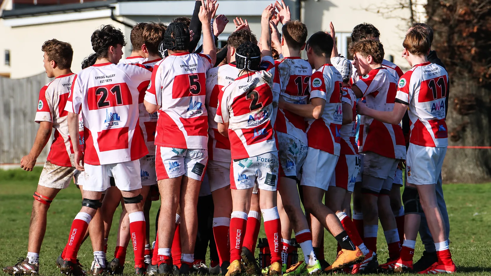 Epping Upper Clapton RFC Under-15s team huddle, JJS branding on shirts